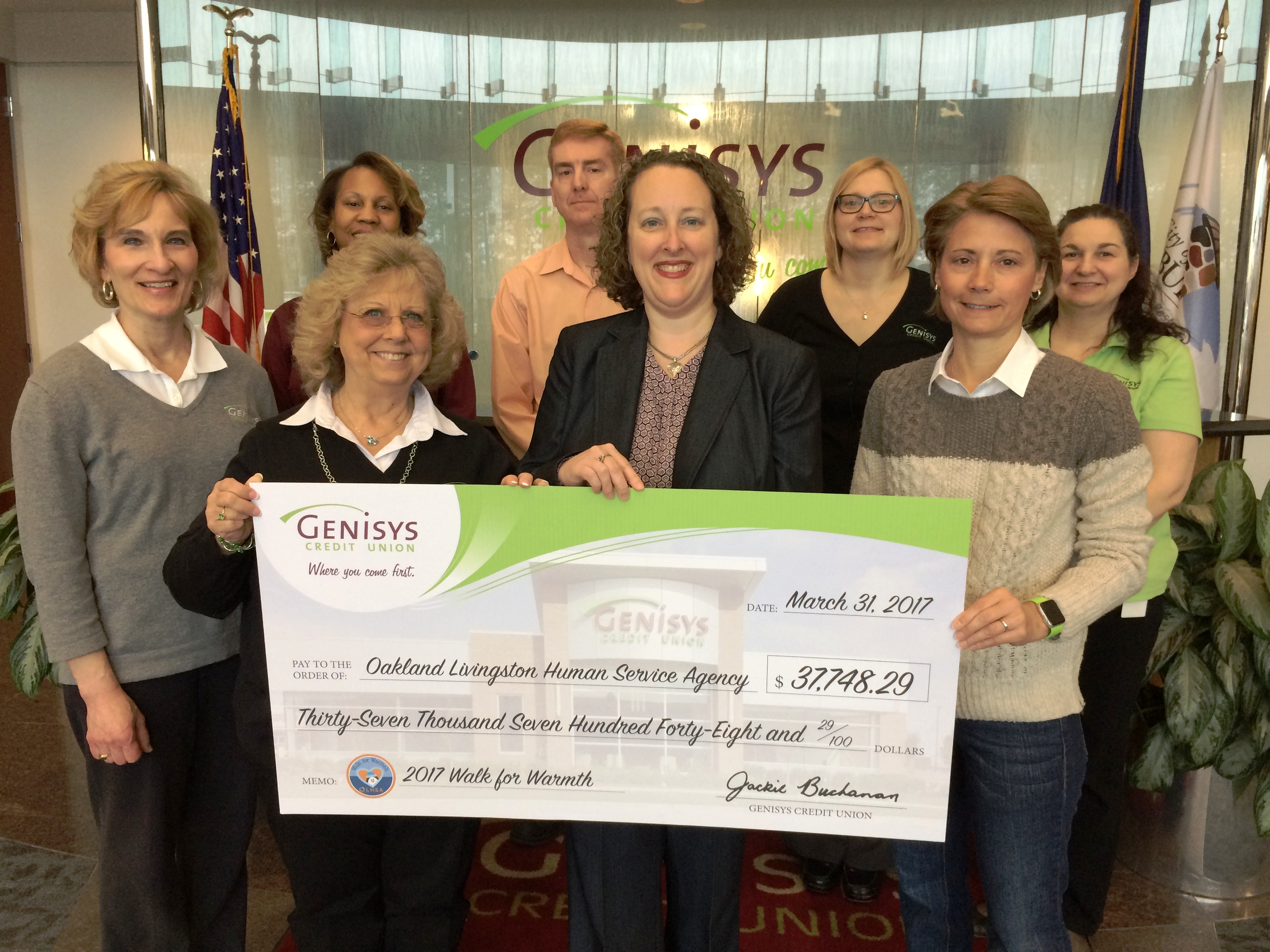 Genisys Staff presenting check